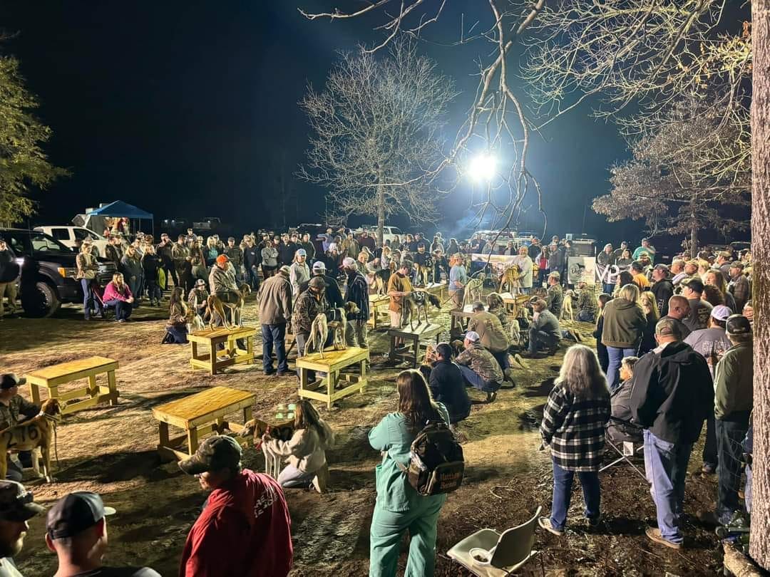 A crowd of people standing around in the dark.